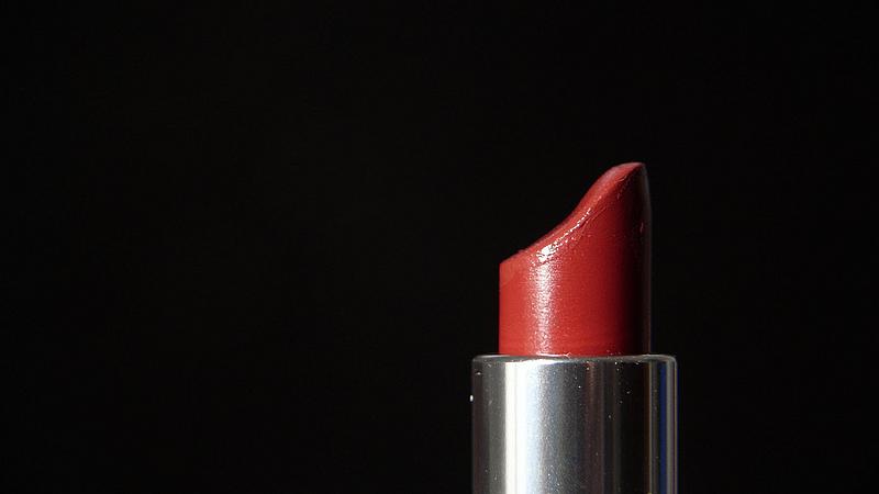 Roter Lippenstift vor schwarzem Hintergrund