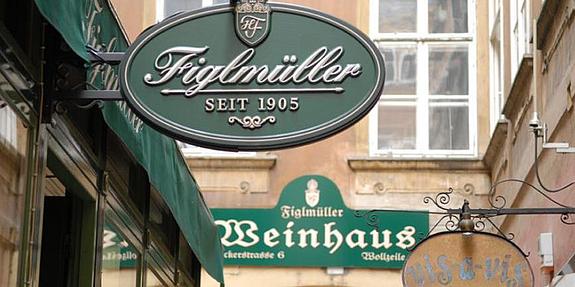 Grünes Schild mit Inschrift Figlmüller vor dem Eingang des Restaurants in 1010 Wien