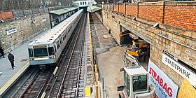 Die Baustelle der Station Stadtpark. Eine U-Bahn fährt durch die Station, welche gerade renoviert wird. 