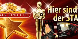 Ein roter Flyer mit dem Lugner Kino City Logo, einer Oscar Figur und der Aufschrift "Hier sind Sie der Star"