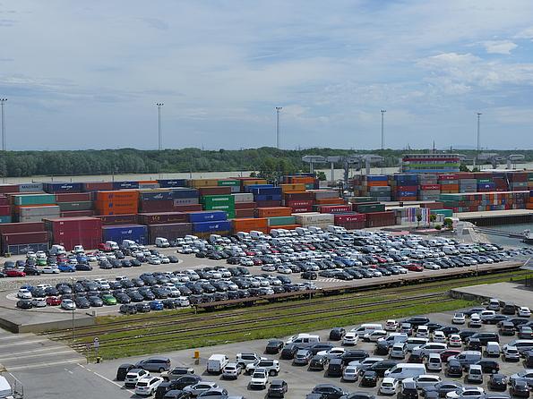Zahlreiche belegte Parkplätze vor den noch zahlreicheren Containern am Hafen Wien