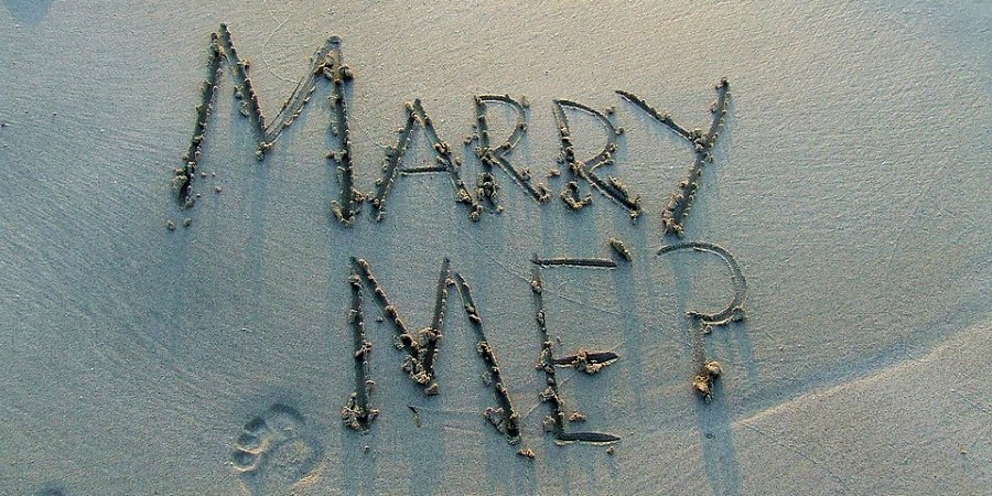 Schrift im Sand "Willst du mich heiraten?"