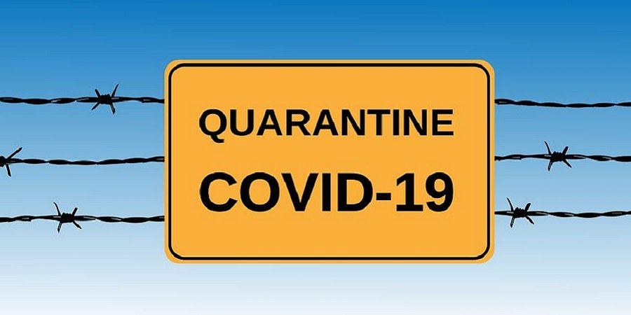 oranges Ortsschild mit der Aufschrift Quarantine CoVid-19