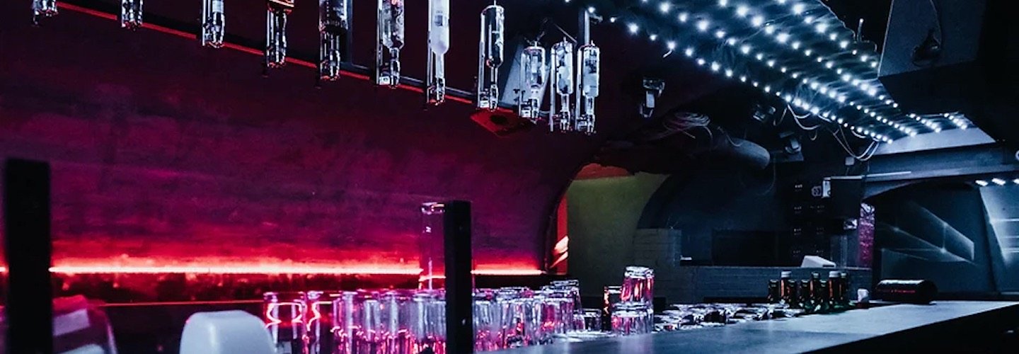 Bar in Nachtclub, erleuchtet von rotem Neonlicht